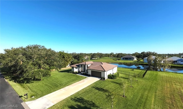 birds eye view of property with a water view