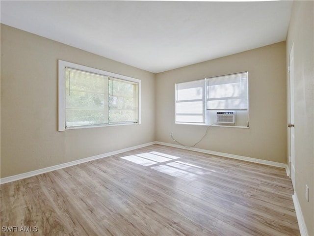 unfurnished room with light hardwood / wood-style flooring and cooling unit