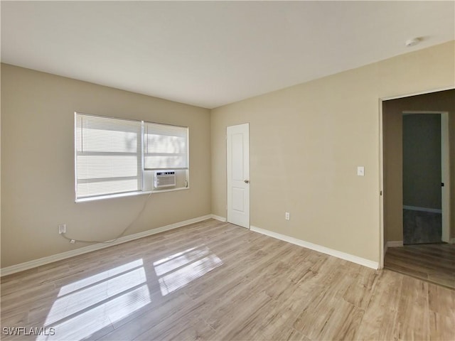 unfurnished room featuring light hardwood / wood-style flooring and cooling unit