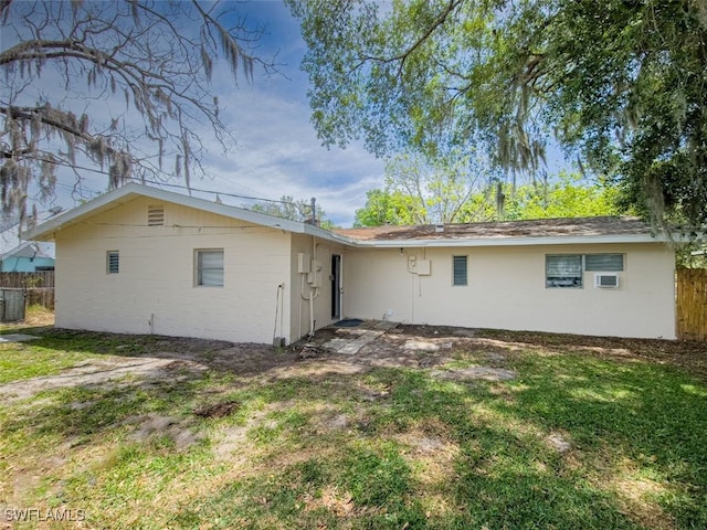 rear view of house featuring a yard