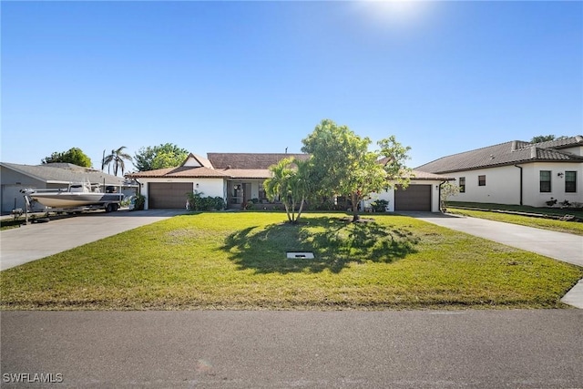 view of front of house featuring a garage and a front lawn