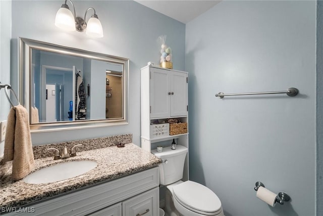 bathroom with toilet and vanity