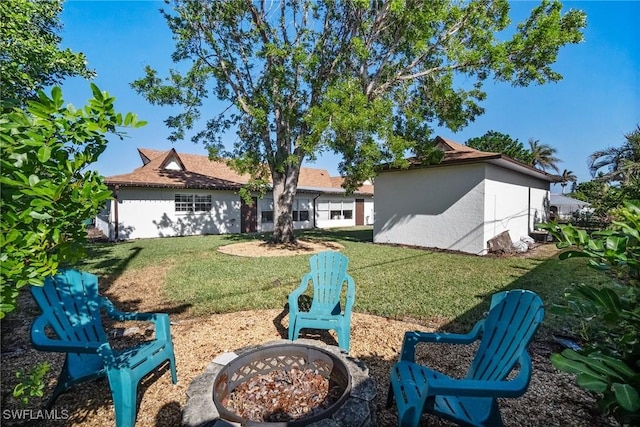 view of yard with an outdoor fire pit