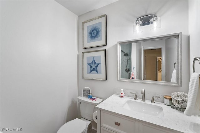 bathroom featuring toilet and vanity