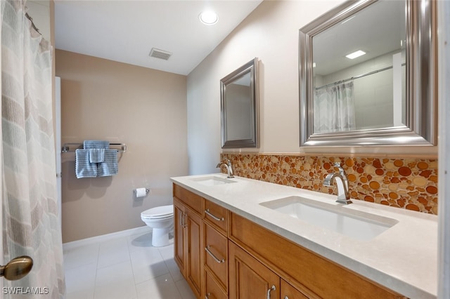 bathroom with tile patterned floors, backsplash, vanity, and toilet