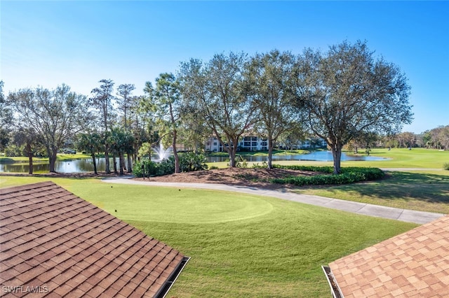 view of community with a lawn and a water view