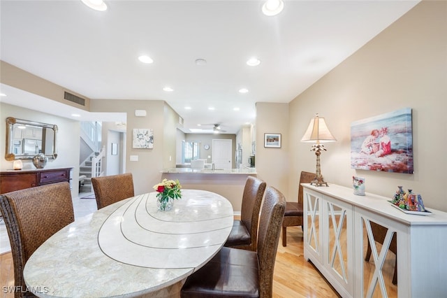 dining area featuring light wood-type flooring and ceiling fan