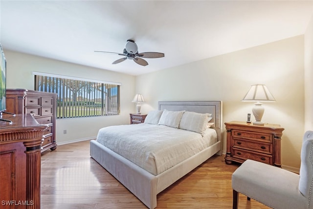 bedroom with ceiling fan and light wood-type flooring