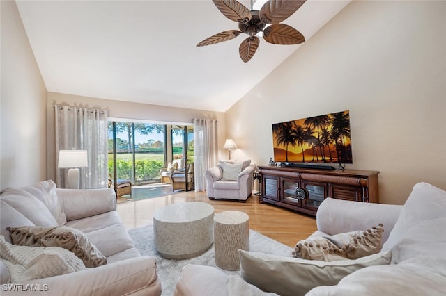 living room featuring high vaulted ceiling, ceiling fan, and light hardwood / wood-style flooring