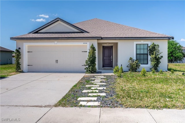 single story home featuring a garage and a front lawn