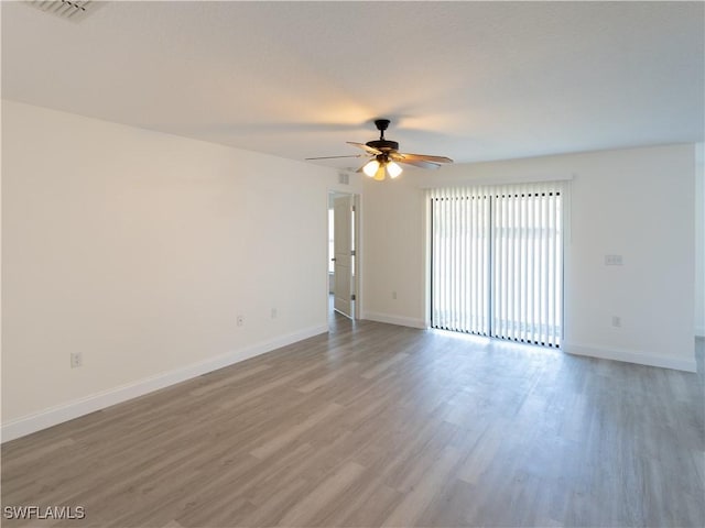 unfurnished room featuring ceiling fan and hardwood / wood-style flooring