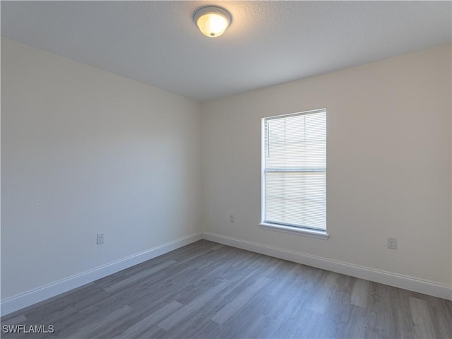 spare room with hardwood / wood-style floors