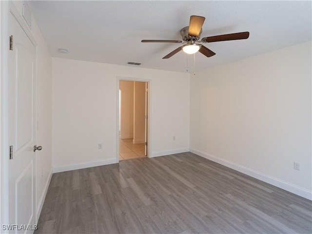 unfurnished room featuring ceiling fan and light hardwood / wood-style flooring