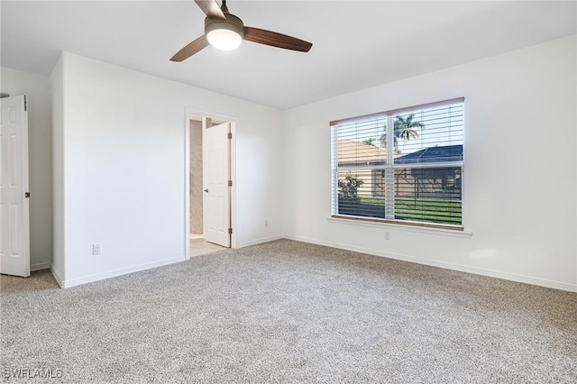 empty room featuring light carpet and ceiling fan