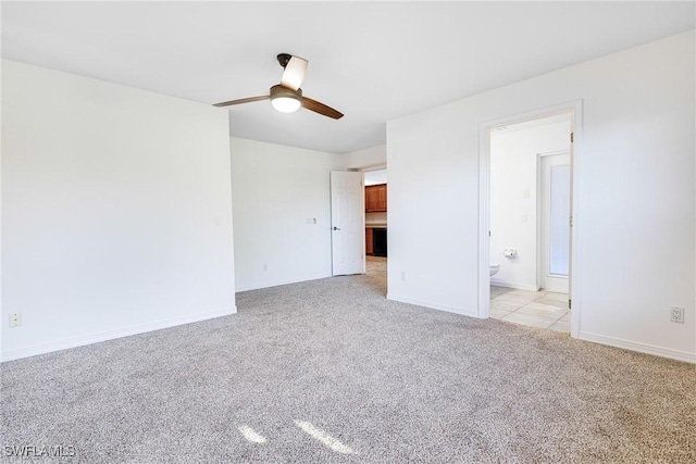 empty room featuring ceiling fan and light colored carpet