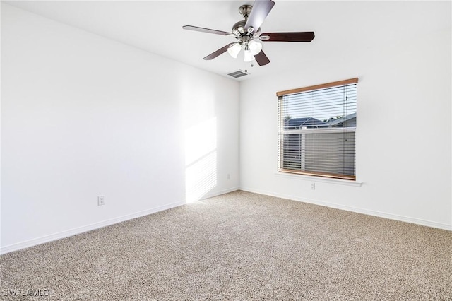 carpeted spare room featuring ceiling fan