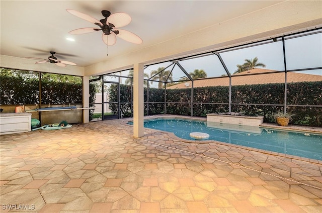 view of pool featuring a patio area, ceiling fan, and glass enclosure