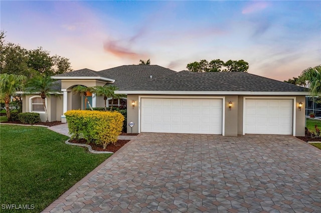 ranch-style house with a lawn and a garage