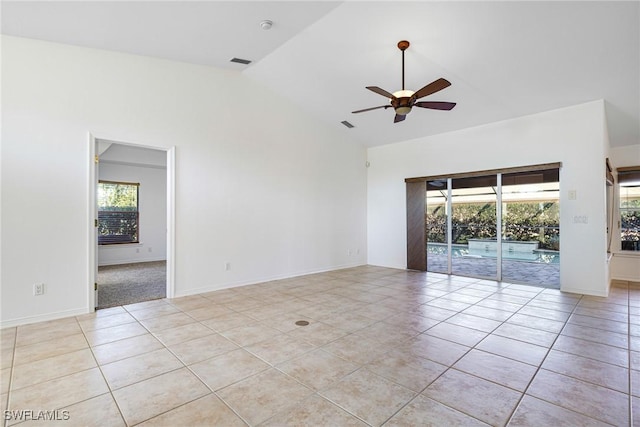 tiled spare room with lofted ceiling and ceiling fan