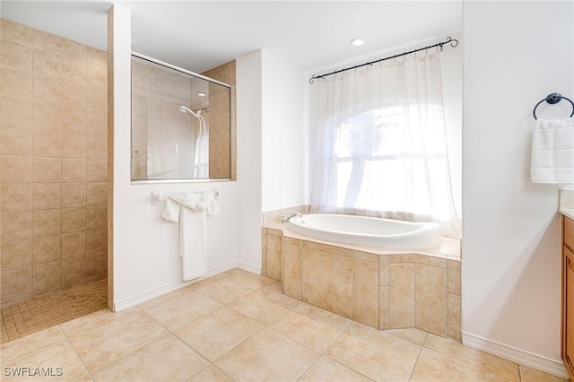 bathroom with tile patterned flooring, independent shower and bath, and vanity