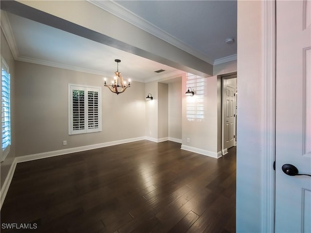 empty room featuring dark wood-type flooring, crown molding, and an inviting chandelier