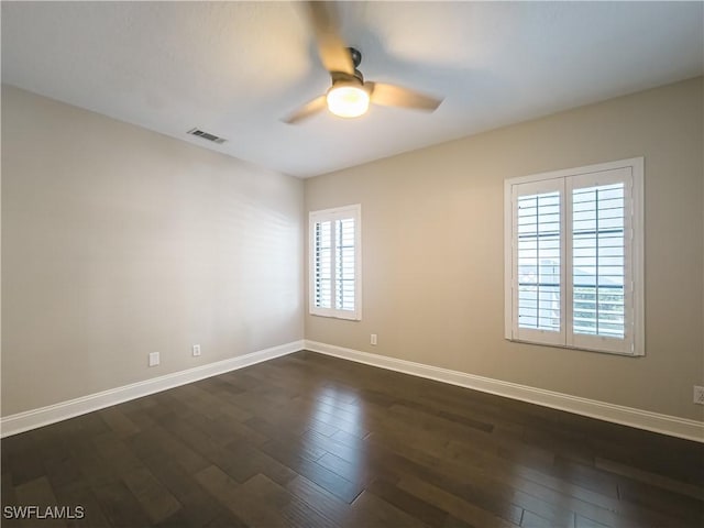 unfurnished room with ceiling fan, a healthy amount of sunlight, and dark hardwood / wood-style flooring