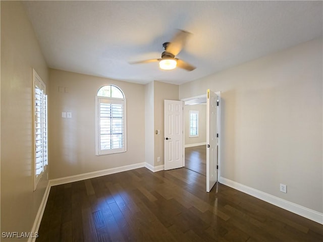 spare room with dark hardwood / wood-style floors and ceiling fan