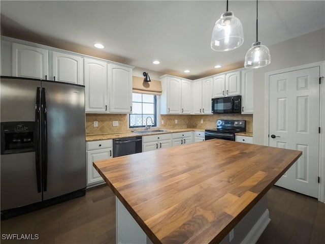 kitchen featuring black appliances, wood counters, and white cabinets