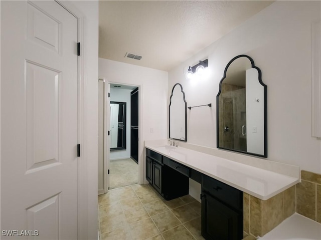 bathroom with vanity and walk in shower