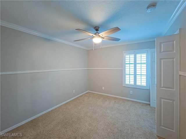 empty room with ceiling fan and crown molding