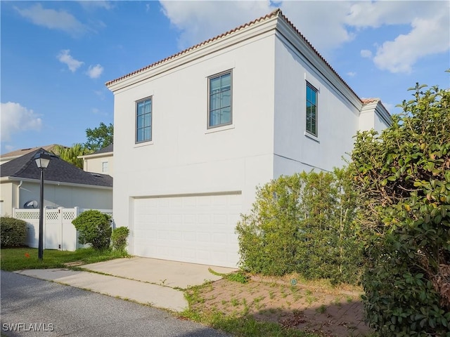 view of side of property with a garage