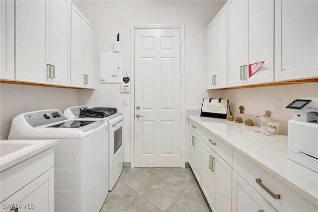 10064 Chesapeake Bay Dr, Fort Myers, FL 33913 - washroom with independent washer and dryer, cabinet space, and light tile patterned flooring