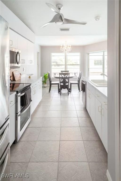 kitchen with white cabinetry, sink, a healthy amount of sunlight, and appliances with stainless steel finishes