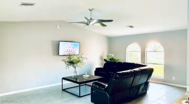 tiled living room featuring ceiling fan