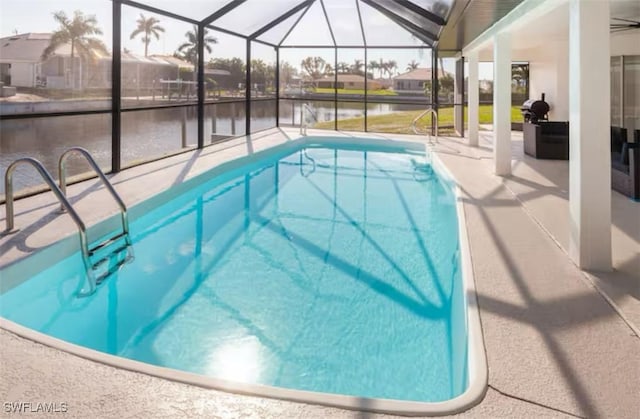 view of pool with a lanai, a water view, and a patio