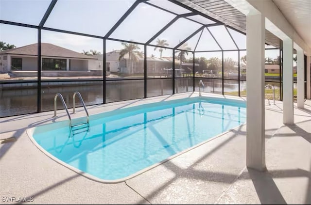 view of pool featuring a lanai, a patio area, and a water view