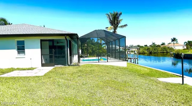 exterior space with glass enclosure and a water view