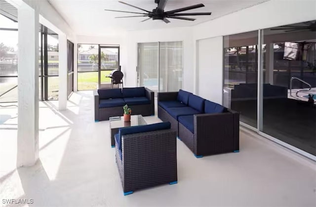 sunroom featuring ceiling fan