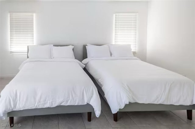 bedroom with light tile patterned floors