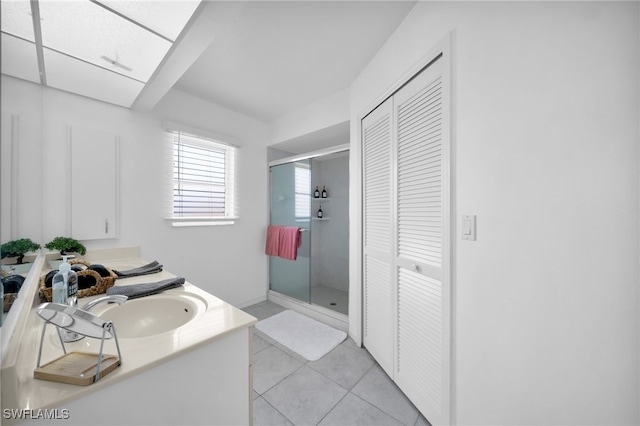 full bathroom featuring a shower stall, tile patterned flooring, a closet, and vanity