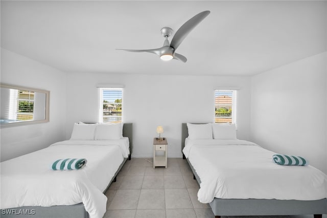 bedroom featuring light tile patterned floors and ceiling fan