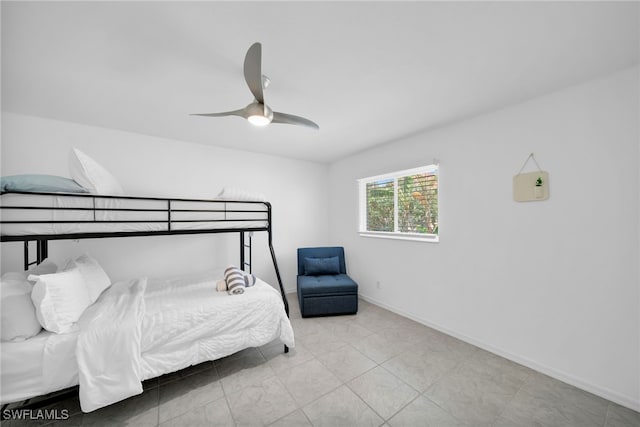 bedroom with ceiling fan and baseboards