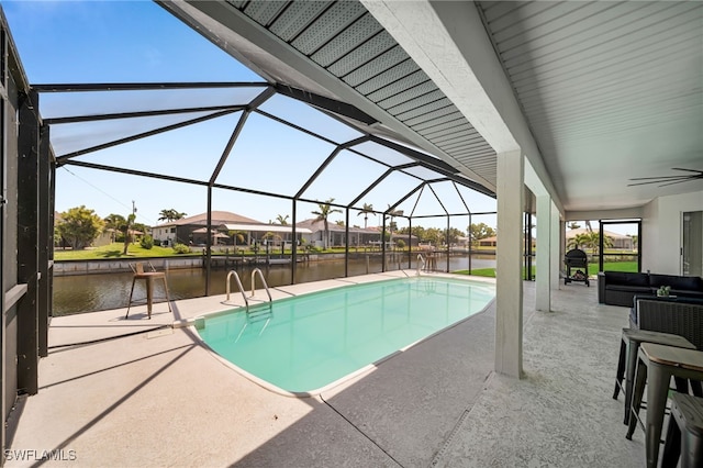 outdoor pool with a lanai, ceiling fan, a water view, and a patio