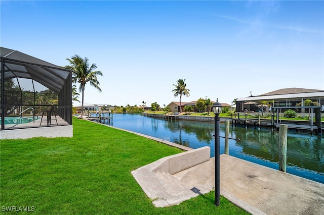 exterior space featuring a lawn, a water view, and a boat dock