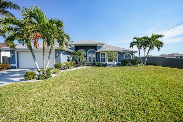 view of front facade with a garage and a front lawn