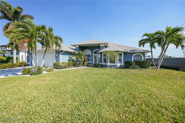 view of front facade with a front yard and a garage