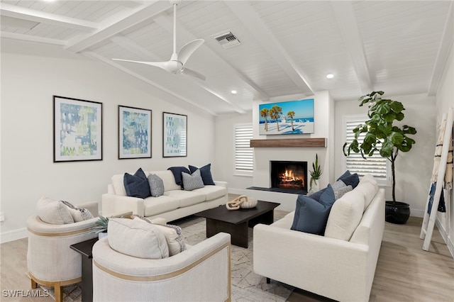 living room with lofted ceiling with beams, light hardwood / wood-style floors, and ceiling fan