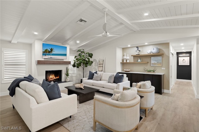 living room featuring light wood-type flooring, lofted ceiling with beams, a wealth of natural light, and ceiling fan