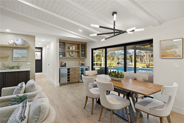 dining area featuring a notable chandelier, vaulted ceiling with beams, light hardwood / wood-style floors, and beverage cooler