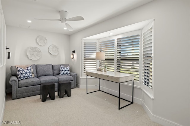 carpeted living room with ceiling fan